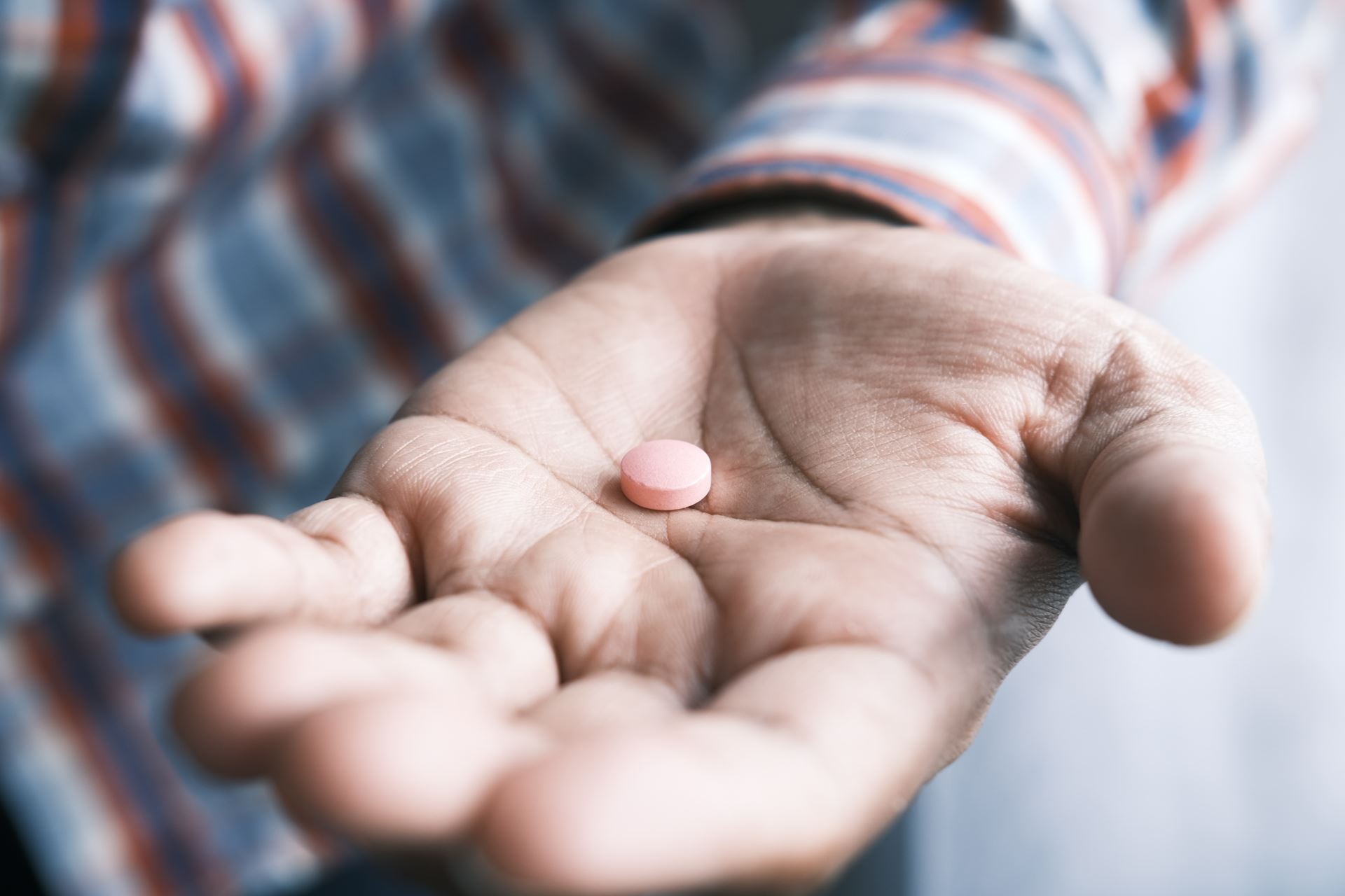 hand holding a pill